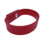 A red silicone wristband with a logo, featuring embossed text. The band is flexible and suitable for events.
