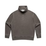 A faded half-zip jacket in a muted green colour, featuring long sleeves and a standing collar. It has a logo on the front.