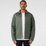 A green service jacket with a collared neck and a zip front, worn over a white t-shirt, displayed against a neutral background.